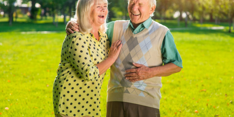 Couple of seniors laughing. Old people outdoors. Not a day without laughter. Look at everything with humor.