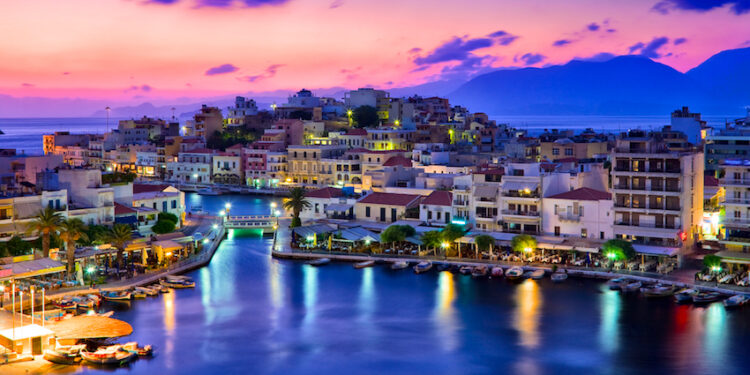Agios Nikolaos. Agios Nikolaos is a picturesque town in the eastern part of the island Crete built on the northwest side of the peaceful bay of Mirabello.